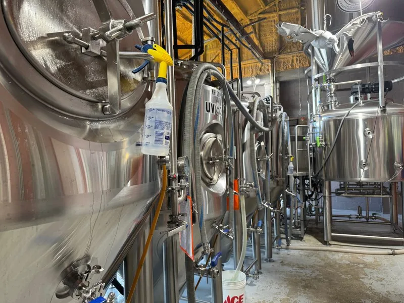 Rows of stainless steel fermentation tanks in the Swan Brewing production space
